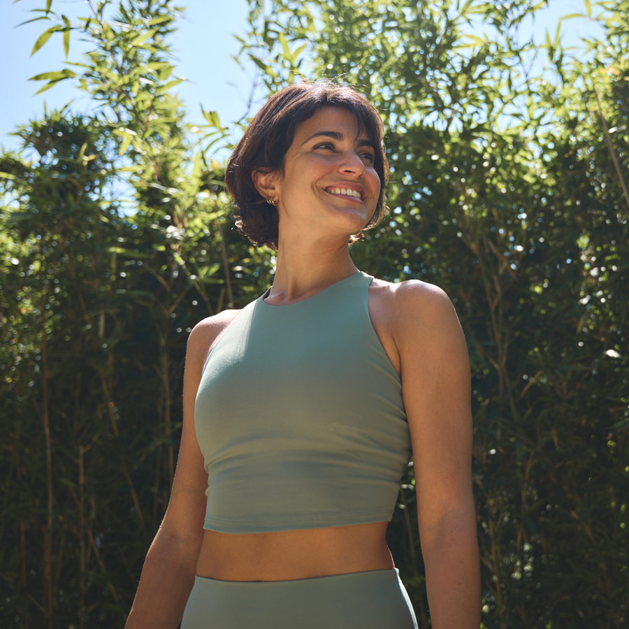 Happy fit sporty active confident young Hispanic woman wearing sportswear enjoying summer sunny day looking away feeling peace of mind