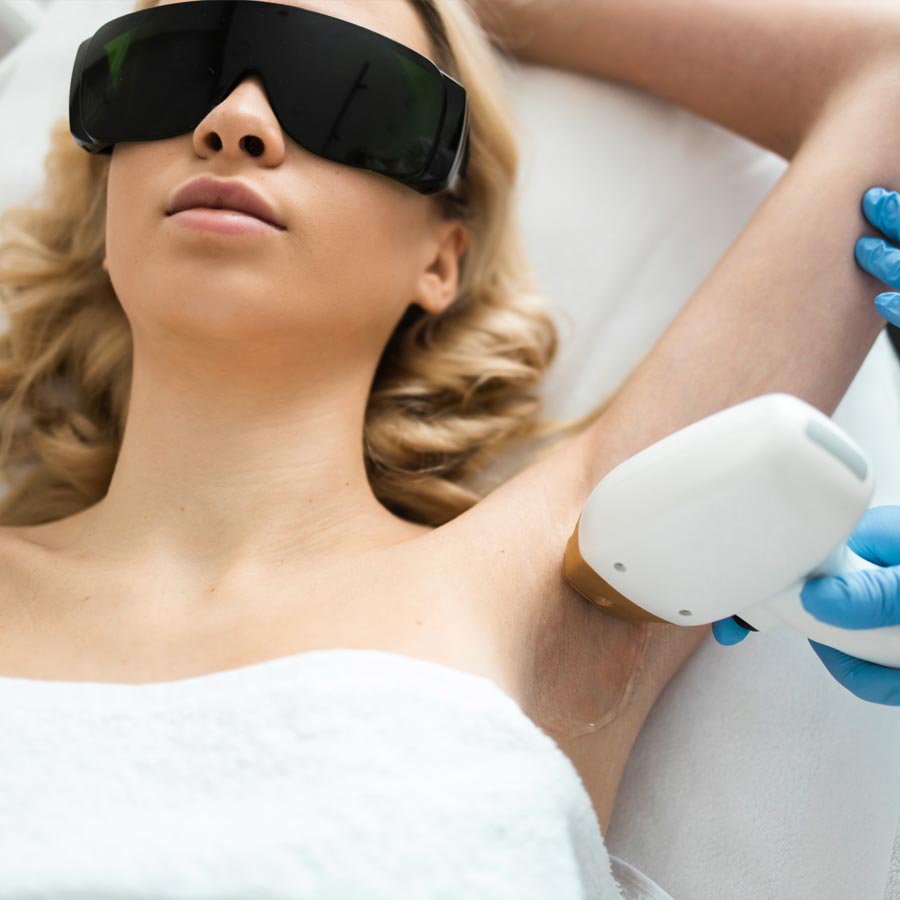 Underarm laser epilation. Beautician removing hair of young woman's armpit. Smooth skin concept