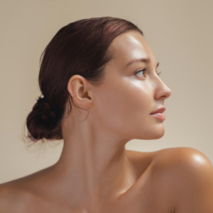 Elegant Side View of Woman with Glowing Skin in Minimalist Beauty Portrait