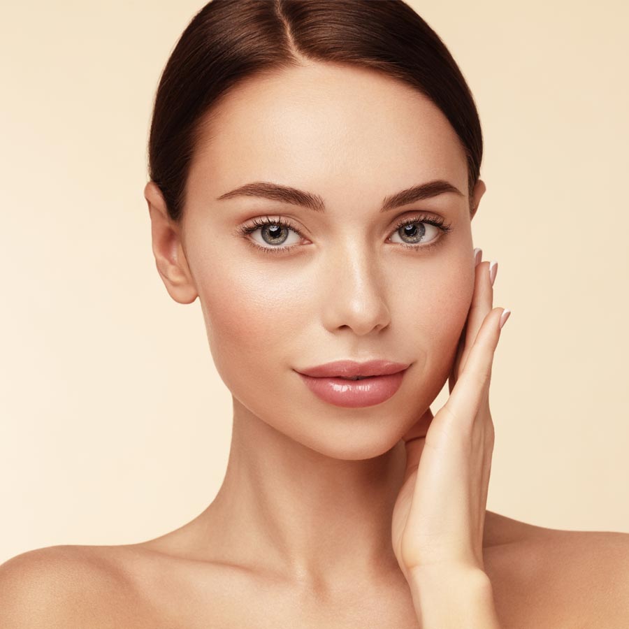 Skin care,Beauty treatment and spa concept. Attractive model with brown hair and Clean Fresh Skin touch own face