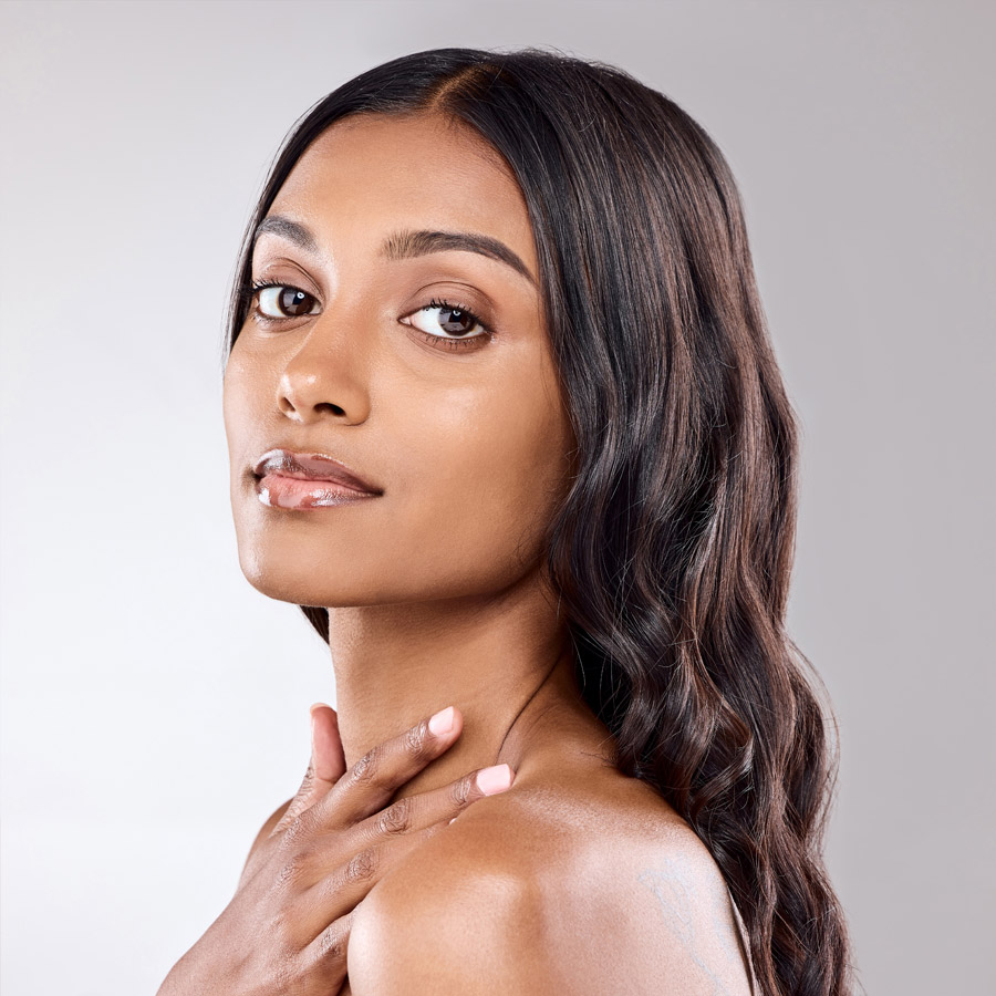 Portrait, skincare and hair care of Indian woman in studio for wellness or beauty isolated on white background.